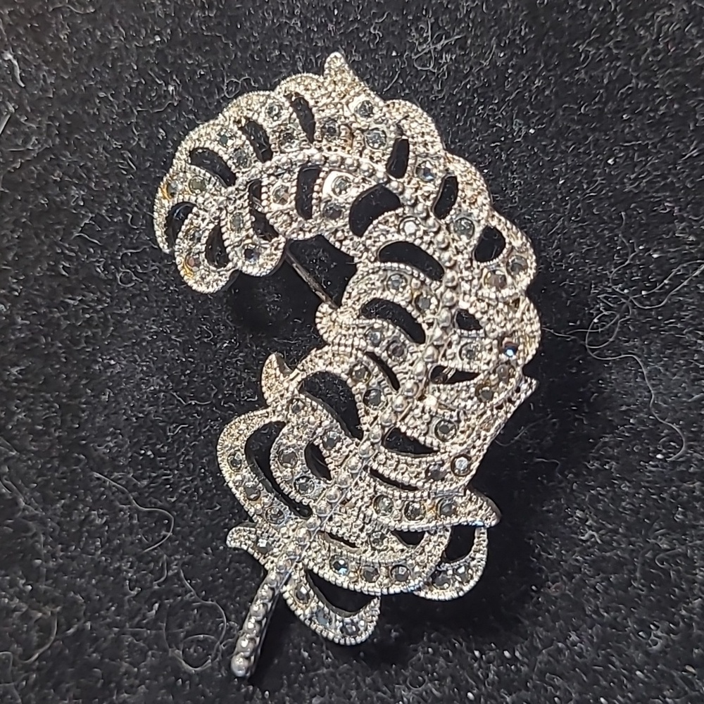 Elegant Silver Toned Feather Brooch Adorned With Crystals